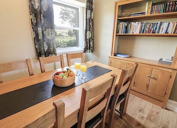 Dining area with wood table and 8 chairs.