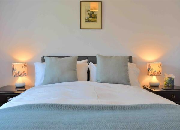 Double bedroom with twin bedside cabinets and table lights.