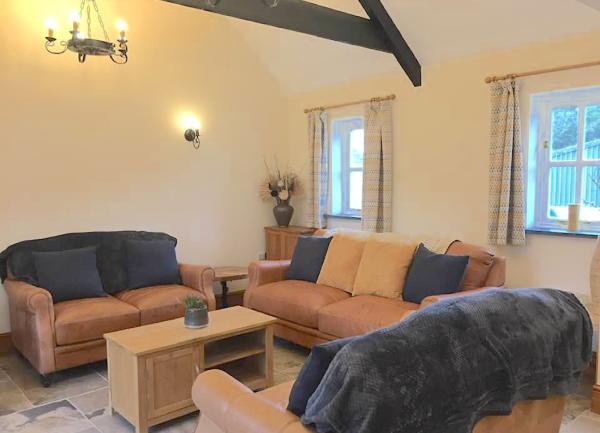 Oak-beamed lounge corner with leather sofas.