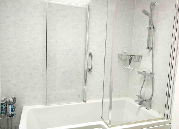 Bathroom with a bath with overhead shower