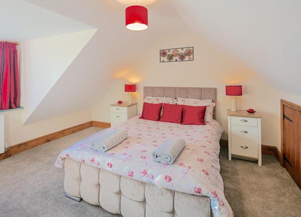Double bedroom with bed and twin bedside tables with lights.