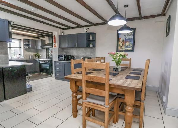 Fitted kitchen with appliances and seperate dining area with table for 6.