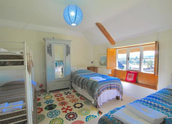 Childrens bedroom with two single beds and bunk beds.