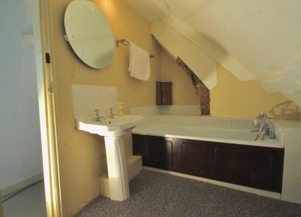 Bathroom with wash basin and bath.
