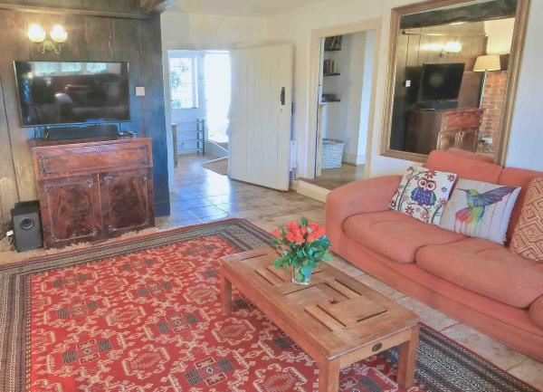 Lounge with sofa, coffee-table and wide-screen-TV.