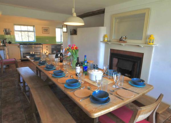 Dining room with table laid for 12 guests.