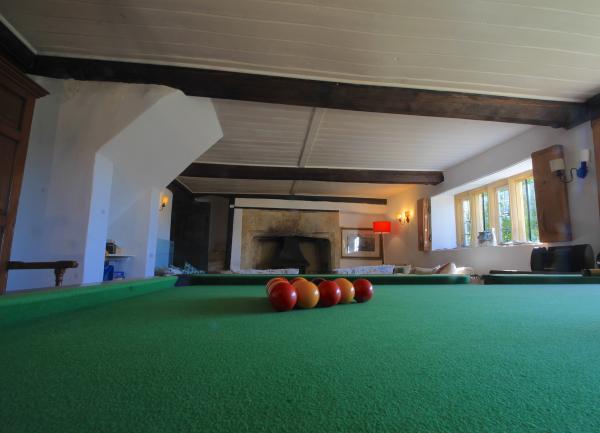 Lounge with inglenook fireplace and snooker table.