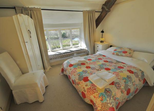 Doublke bedroom with bed, wardrobe and bedside chair.