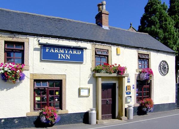 Flower-decked frontage of a Bakewell pub.