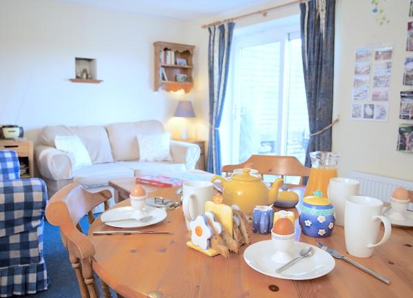 A dining table laid for breakfast for 4.