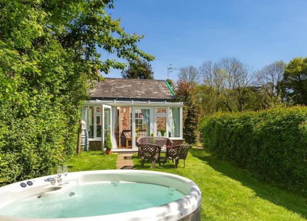 A hot tub in a secure country garden on a sunny summer's day.
