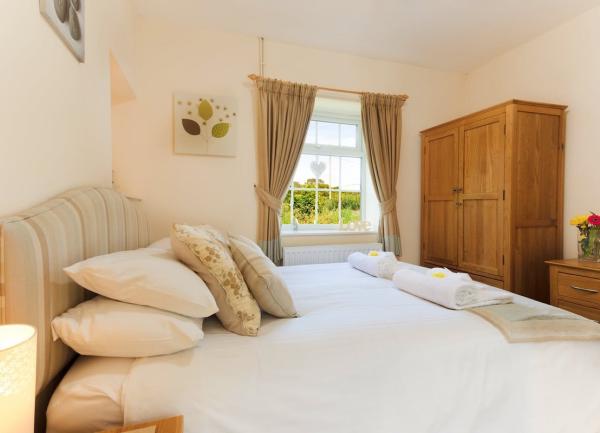 Double bedroom with sash window, wardrobe and a chest-of-drawers