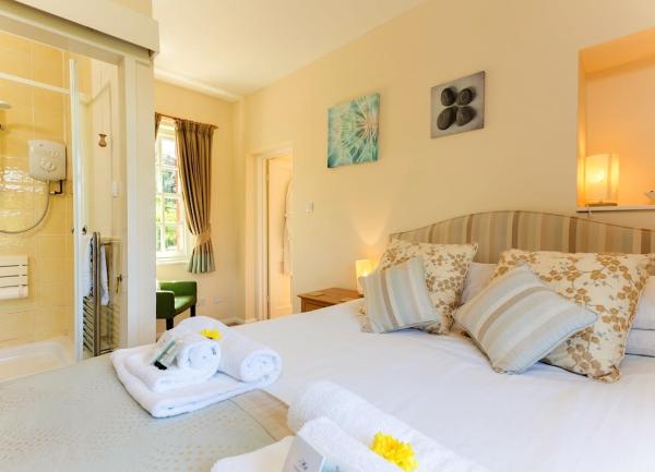 Double bedroom with bed, bedside table and shower cubicle.