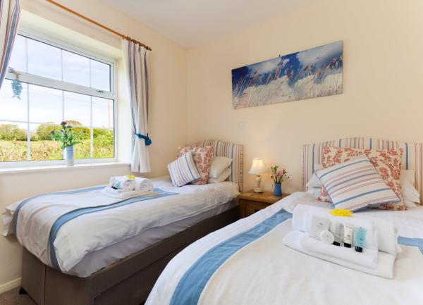 A twin bedroom with a large window offering attractive rural views.