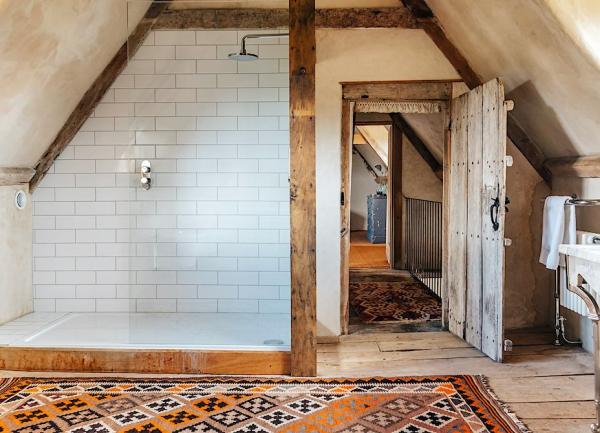 Bathroom with large tiled shower and washbasin.