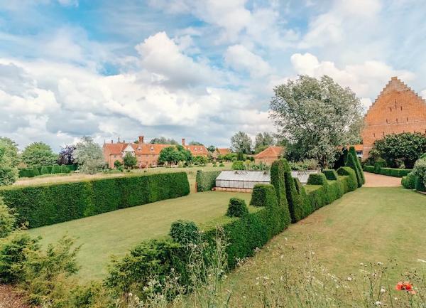 2-lawned garden divided by a sculpted privet hedge.
