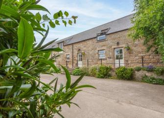 Exterior of a semi-detached, stone-built Alnwick barn conversion