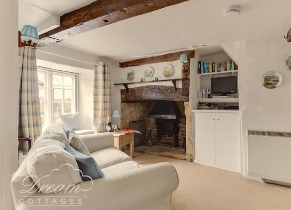 Oak beamed lounge with inglenook fireplace.