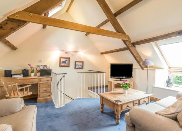 2. Open plan lounge with sofas and a kitchenette with fitted units behind