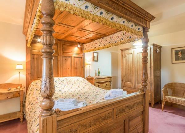 Double bedroom with wardrobe, chest of drawers, dressing table and chair.