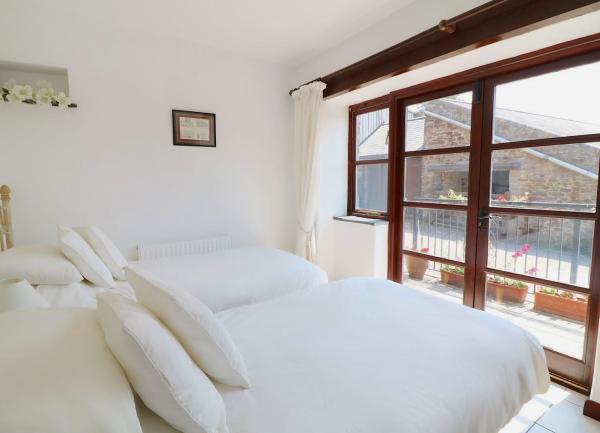 A twin bedroom with French Windows to a balcony.