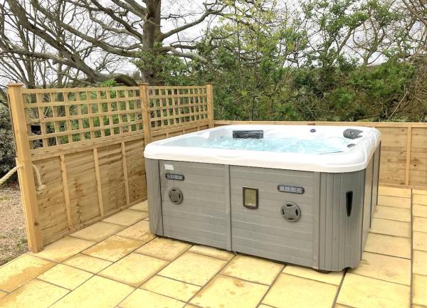 A hot tub on a paved terrace.
