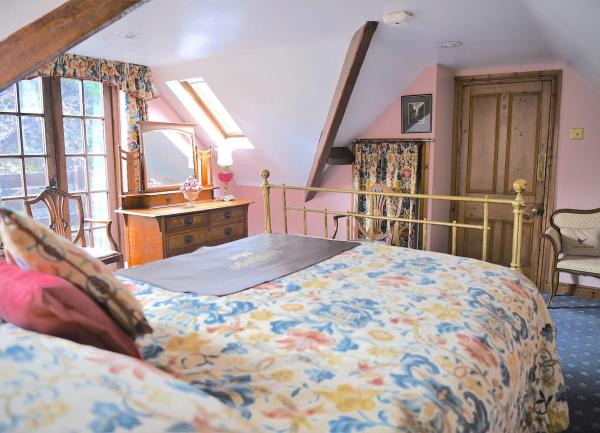 Double bedroom with a brass bed and French windows.