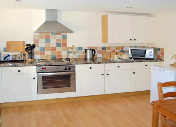 Fitted kitchen. units including an oven and washing machine.