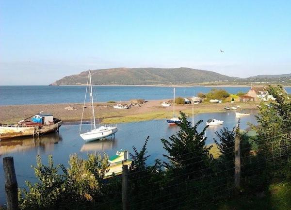 Little boats moored in Porlock Weir harbour at high tide.