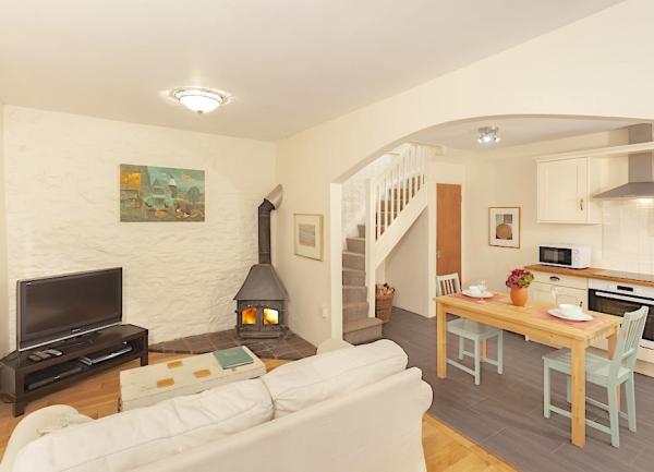 An open plan living area with lounge. dining and kitchen areas