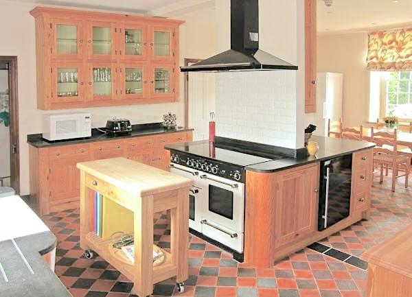 Kitchen with range cooker, butcher's block and fitted cupboards.