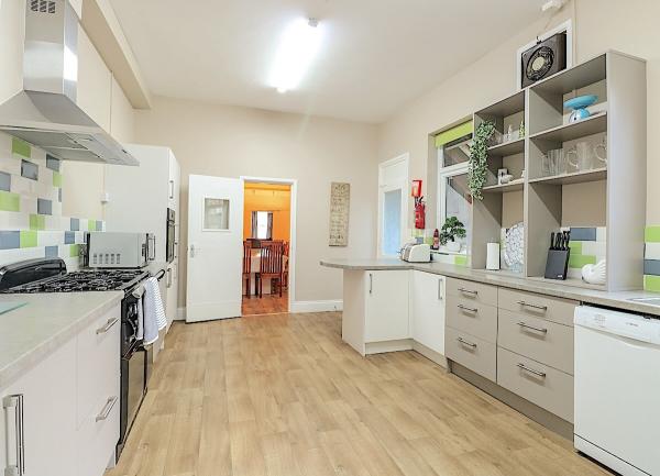 A modern fitted kitchen with. range stove.