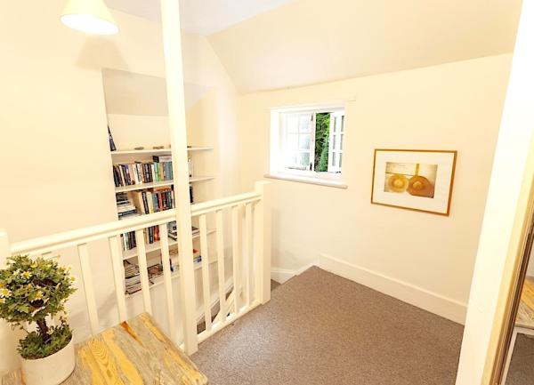 Lookinng down a set of carpeted dog-legged stairs.