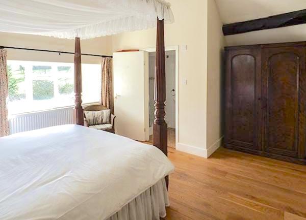 A double bedroom with 4-poster bed and ensuite bathroom.