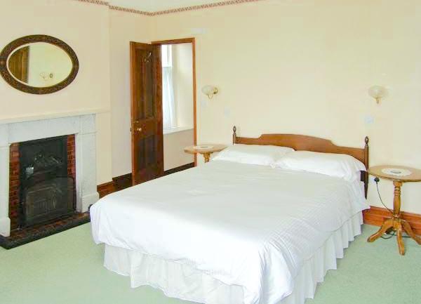 Double bedroom with twin bedside table and wall lights