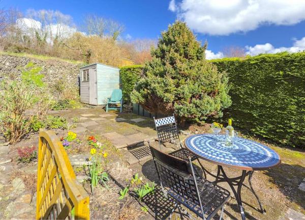 A secluded, sun-trap BBQ terrace with tables and chairs.