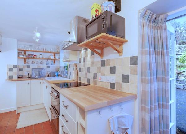 Kitchen units and appliances including a microwave and toaster.