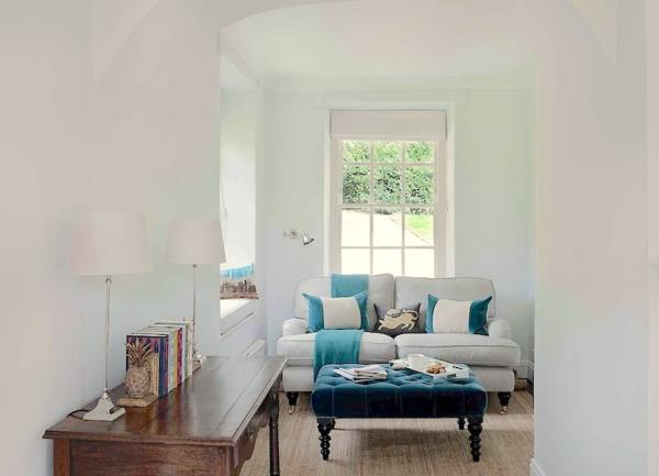 Small living space with a desk, armchair and coffee table.