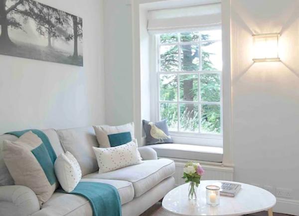 A wall sofa with a coffee table in front.