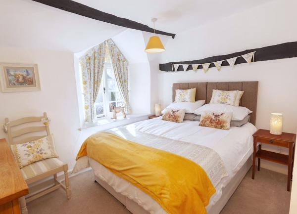 Double bedroom with bed, bedside tables, chair and dressing table.