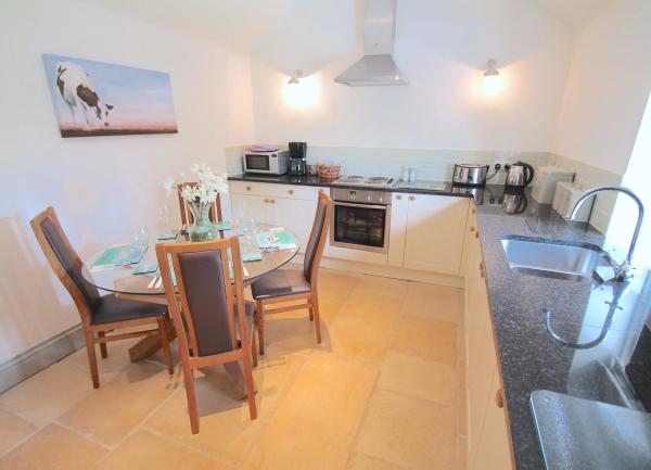 kitchen with a sink, integrated oven, dishwasher, microwave, toaster and kettle.