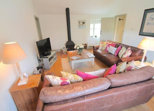 lounge with 2 sofas, TV, wood burner and coffee table