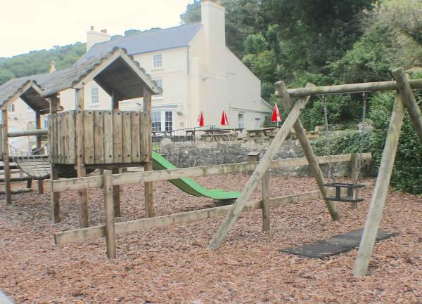 Childrens play equipment including swings and a slide