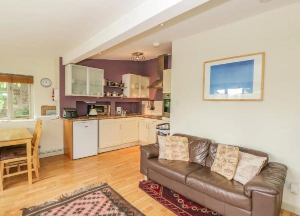 Lounge corner leading to a fitted kitchen.