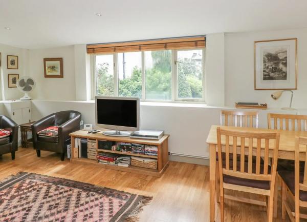 Lounge TV in front of a window with rural views.