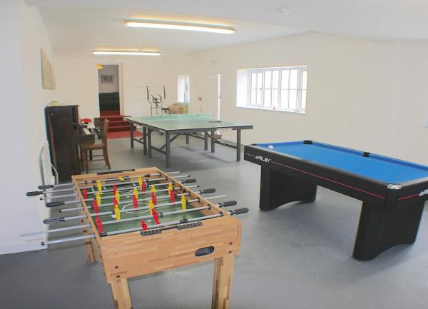 Games room with a piano, football, pool and table tennis tables.