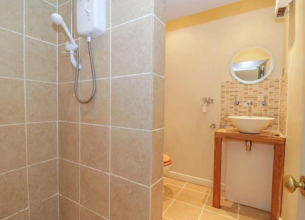 Walk in wet room with shower, washbasin and WC.
