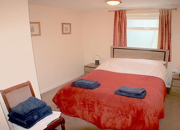 Double bedroom. with twin bedside cabinets with table lights and an armchair.