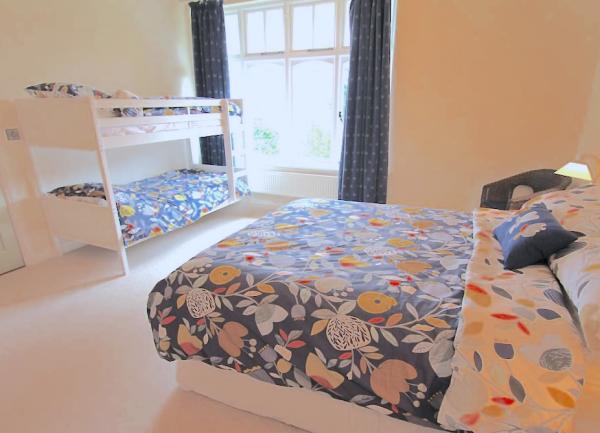 Family bedroom with a double bed and set of bunk beds.