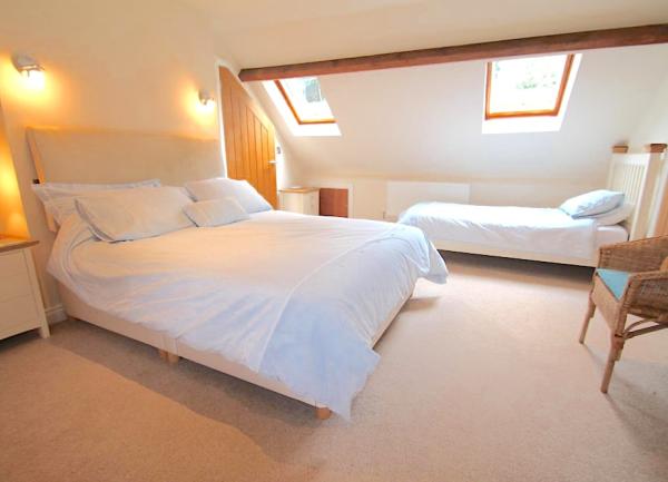 Spacious family bedroom with a double and single bed.